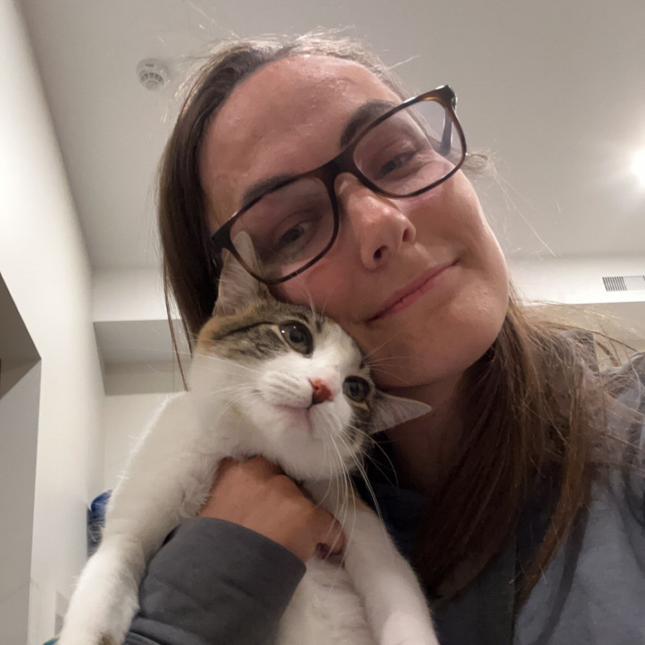 a woman cuddling with her cat