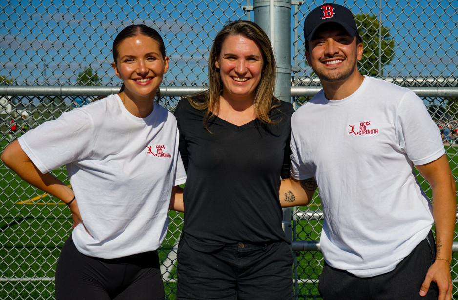 three people standing with arms around each others' shoulders