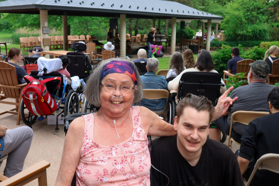A patient and their loved one rock out at a concert