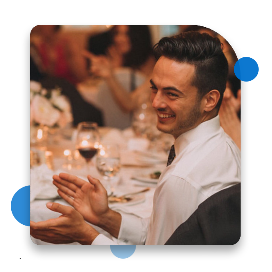 Man clapping at an event table