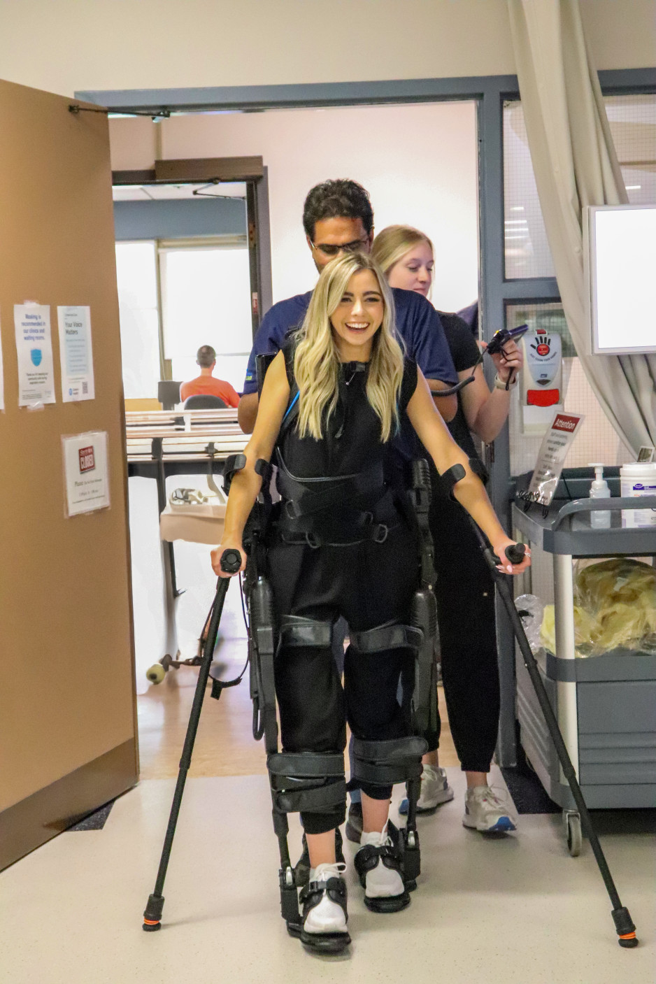 Sarah King, aided by two Physiotherapists, operates the Exso