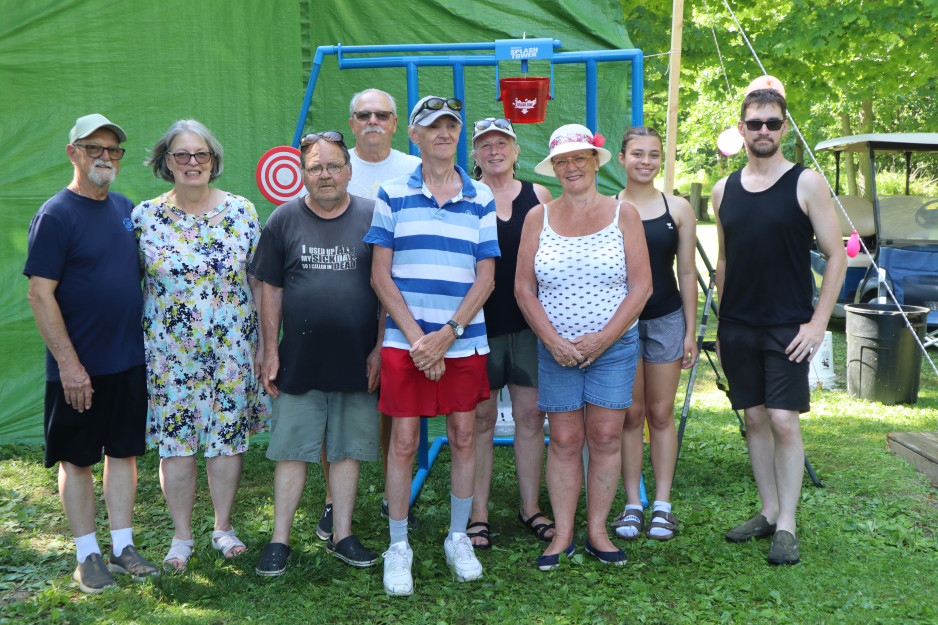 Members of the trailer park community on Lake Erie smile together on a bright sunny day