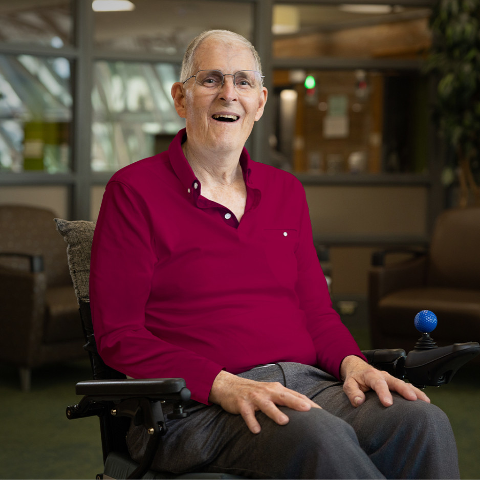 Bill sited on his wheelchair smiling