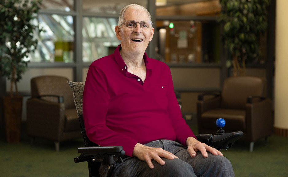 Bill sited on his wheelchair smiling