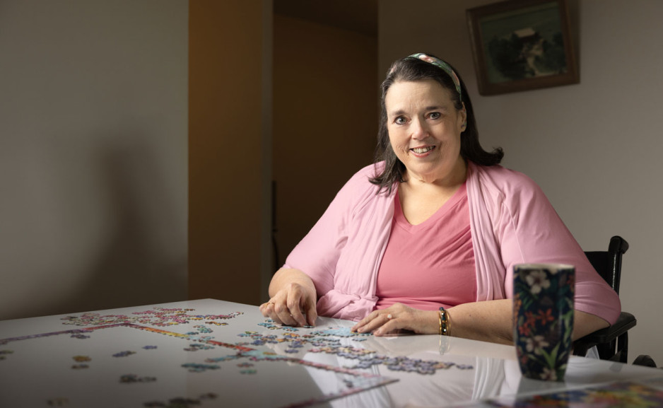 Doris is assembling a puzzle at a table
