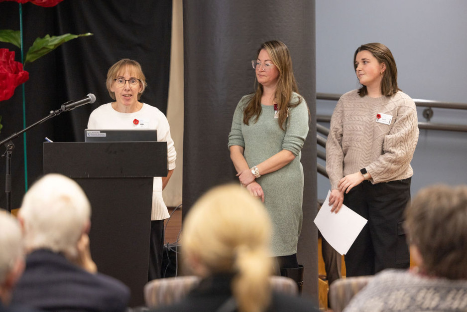 Three members of the speech pathology team take the podium