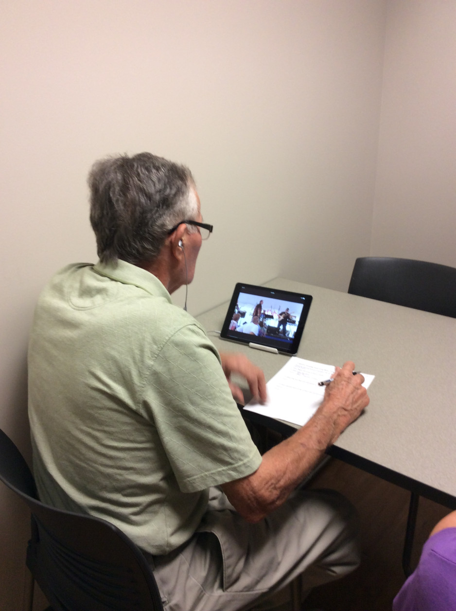 A participant performing cognitive tasks during the SYNERGIC Trial.