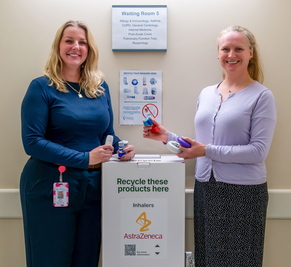two staff members holding inhalers