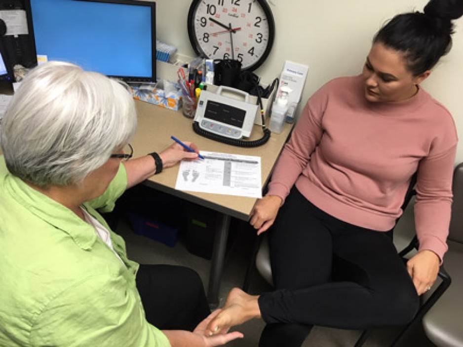Patient being screed with diabetic foot ulcer tool