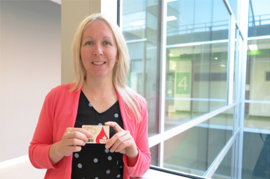 Heather Haley holding her blood donor card