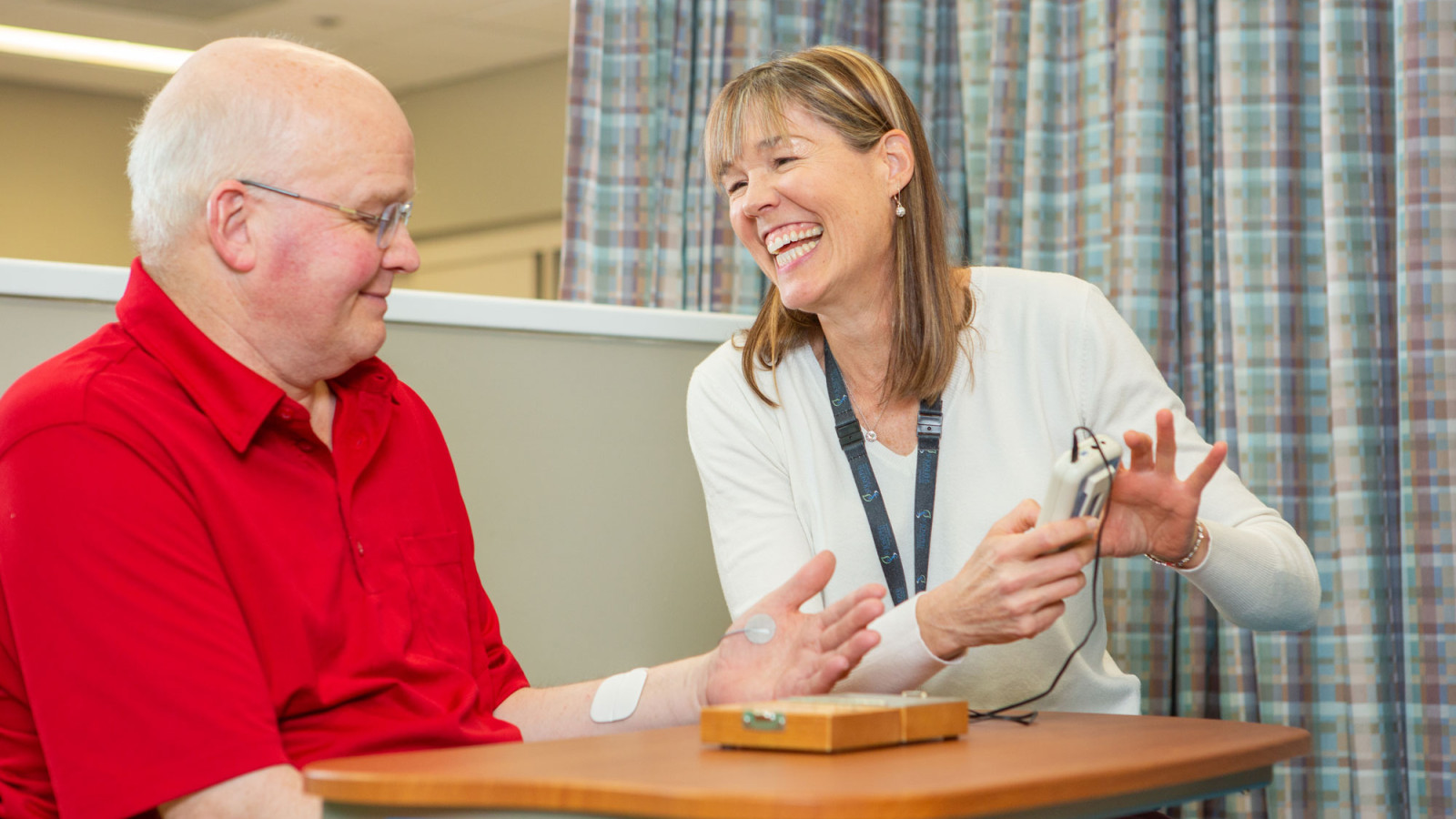 elderly man (patient) with care team member in rehab
