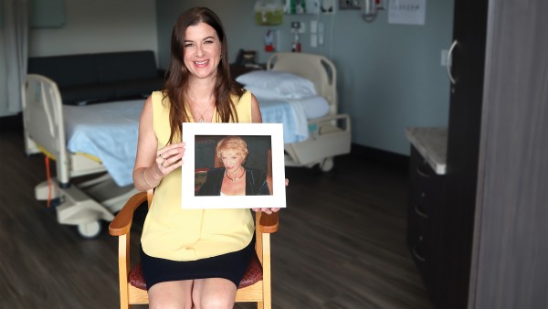 Casandra Haas holds up a photo of her late mother