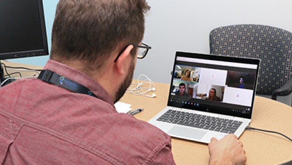 Man sitting in front of a laptop