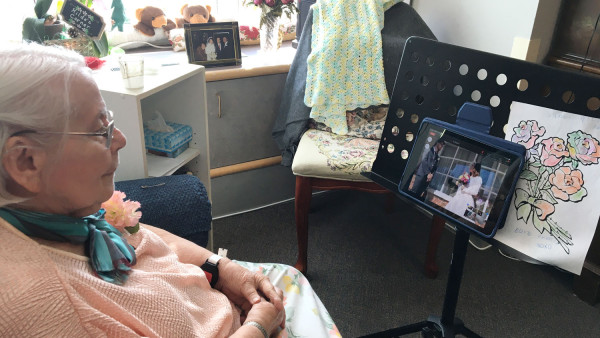Mount Hope resident Hilda Libal watches her grandson's wedding on an iPad