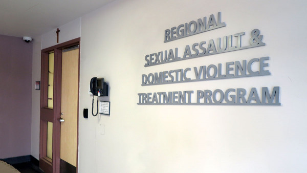doorway and sign on the wall that reads: Regional Sexual Assault and Domestic Violence Treatment Program