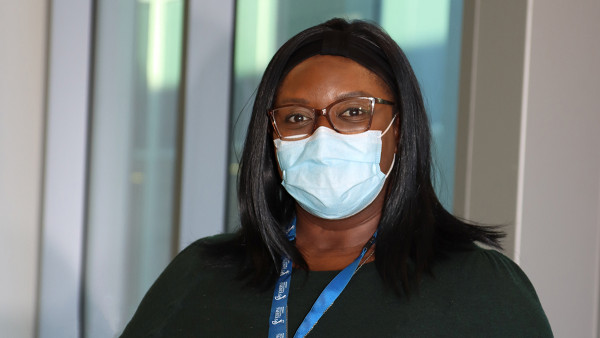 a portrait of a woman who works at St. Joseph's wearing a mask