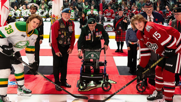 A Veteran drops puck at a ceremony with other notaries and players before the London Knights hockey game 
