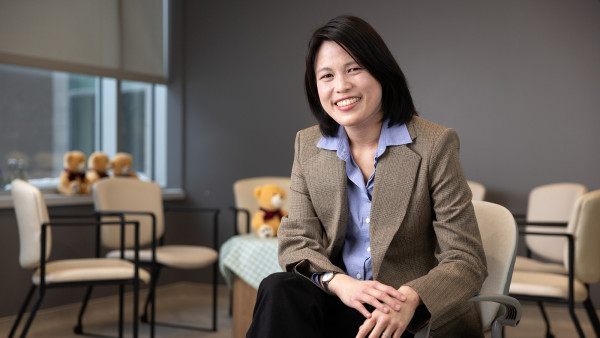 Dr. Serena Wong sitting in a chair.