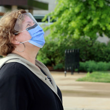St. Joseph's President and CEO Gillian Kernaghan looking up at the newly raised Wampum flag