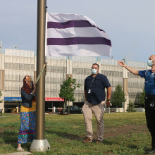 Wampum flag being raised by Belinda King at Parkwood Institute