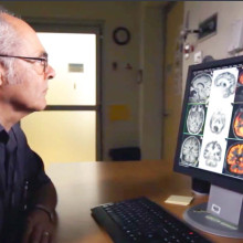 Dr. Frank Prato looks at brain images on computer screen