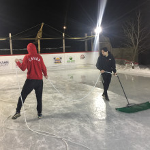 two people cleaning an ice rink