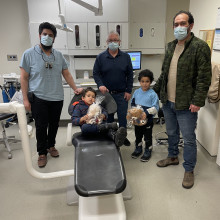 three men and two young children in a doctor's office