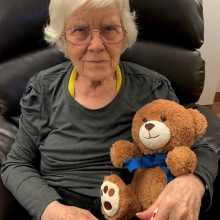 woman cradles a teddy bear