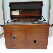 the front of a portable ECG machine in a wooden cabinet