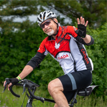 man waving on his bike