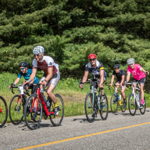 cyclists traveling down road