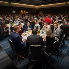 event attendees in ballroom sitting at their tables