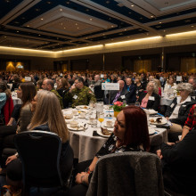event attendees sitting down at their tables and eating breakfast