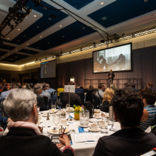 Stéphane Grenier on stage with crowd watching