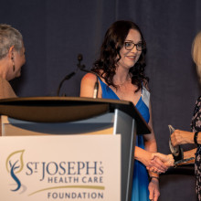 Mary St. Onge accepting award from CMHA leaders