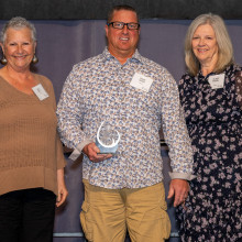 Shaun Taylor holding award with CMHA leadership