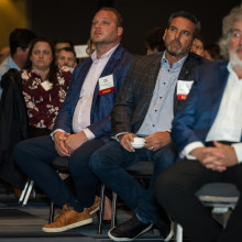 event attendees watching the keynote address at Breakfast of Champions