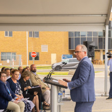 Roy Butler, President and CEO, at podium.