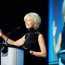 Heather Hiscox at podium on stage