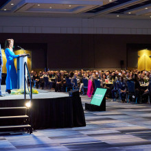 Kim and Paul Spriet walking onto the stage at Tribute Dinner