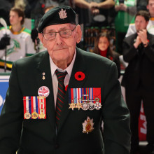 Jack Byrne inside the hockey rink wearing his military uniform