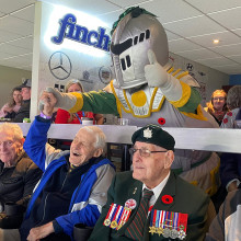 Veterans enjoying the hockey game with the Knights mascot