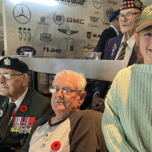 Veterans holding a drawing give to them by a fan