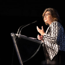 A woman talking at a podium