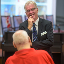 two men facing each other and talking