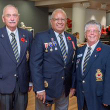 three people in their uniforms smiling