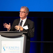 Bill Tucker speaking at a podium
