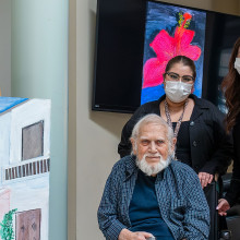 John Lartides, his art display and staff members