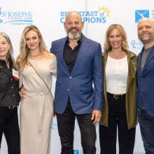 Five people at event smiling