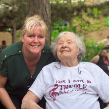 A care provider and patient smile together